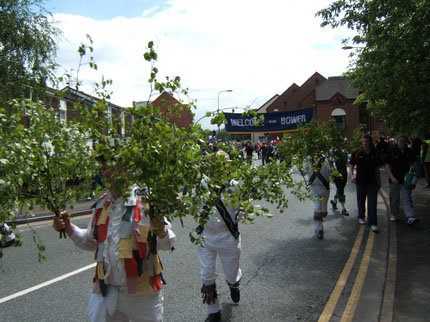 Image of Green men parading with branches